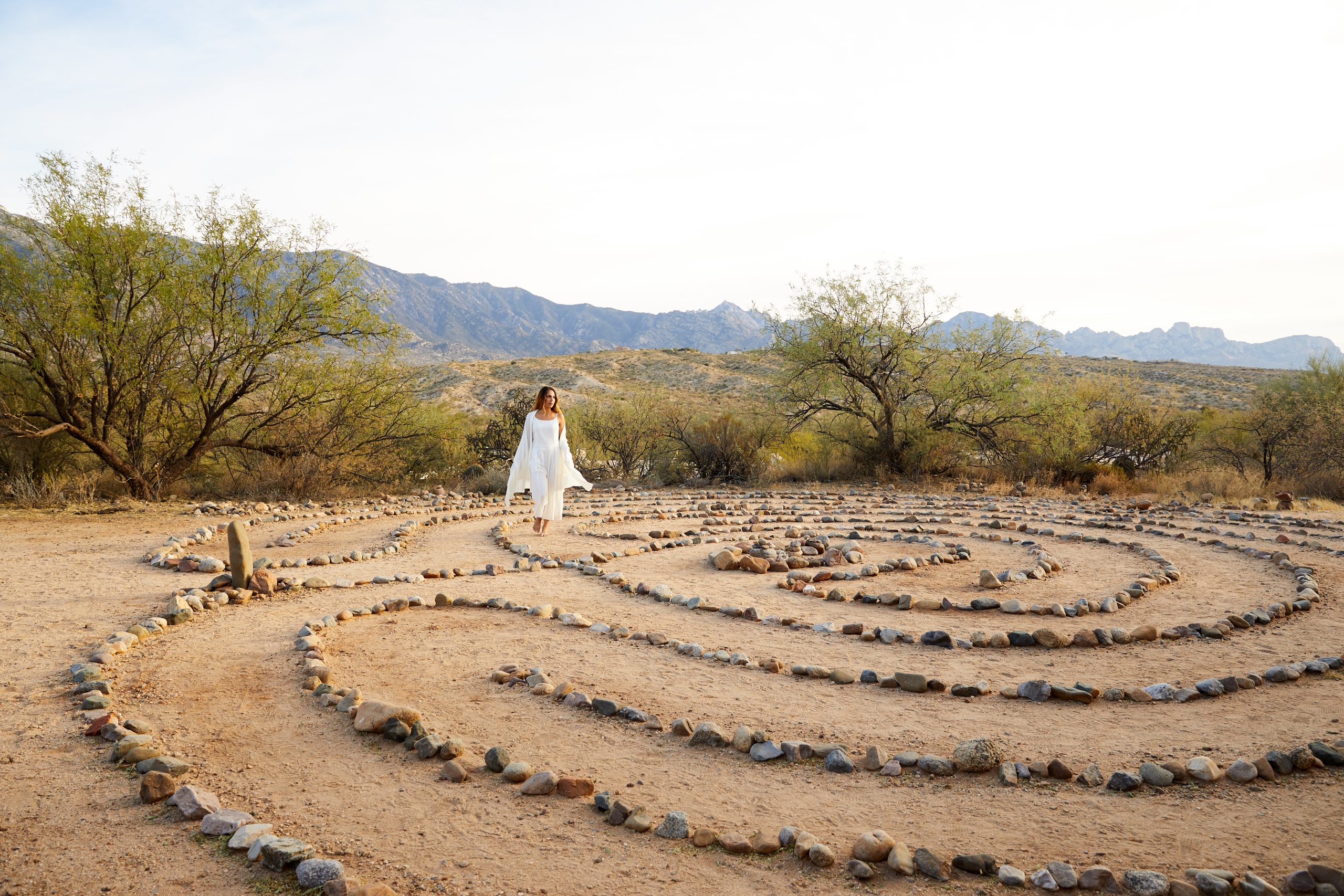 person walking on rock labyrinth