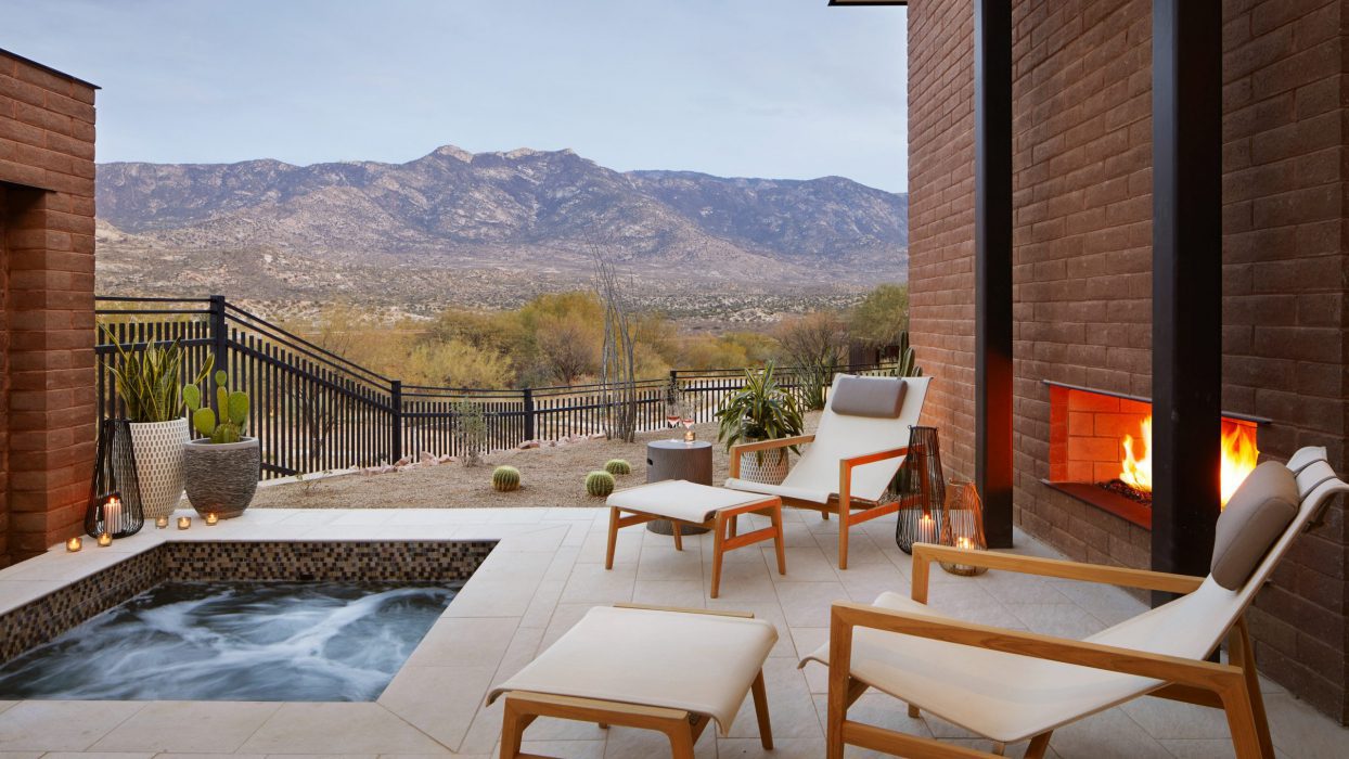 lounge area beside a fireplace and jacuzzi