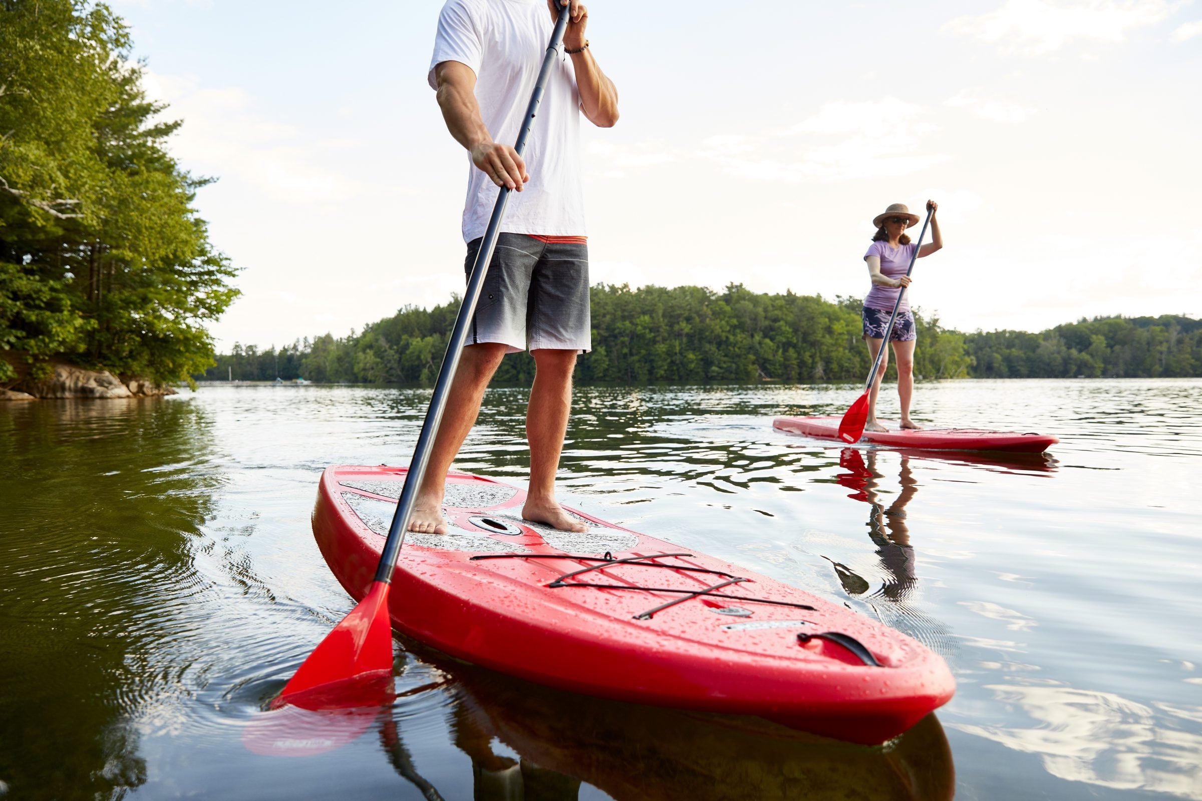 two people stand up paddle boarding