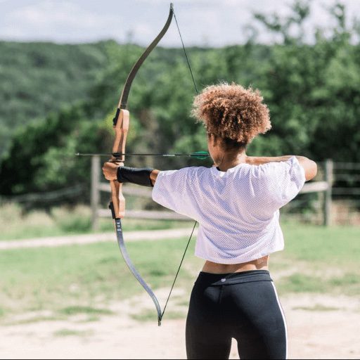 person aiming with a bow and arrow