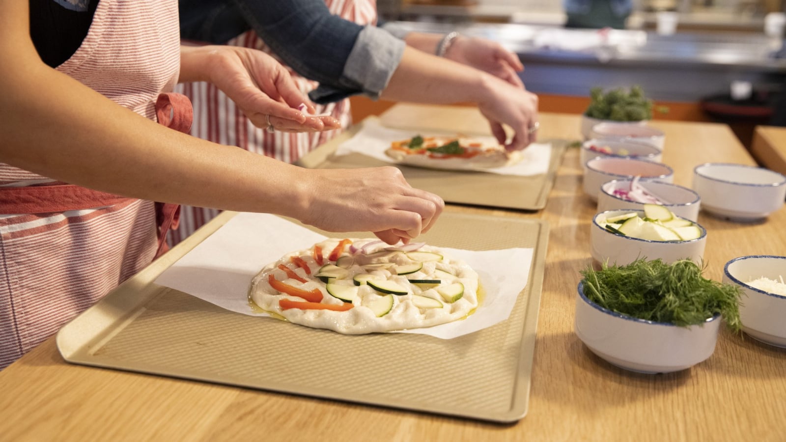 people making a pizza from scratch