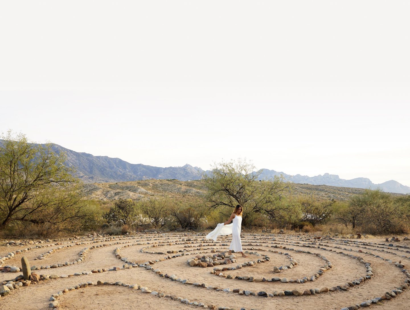 person walking on rock labyrinth