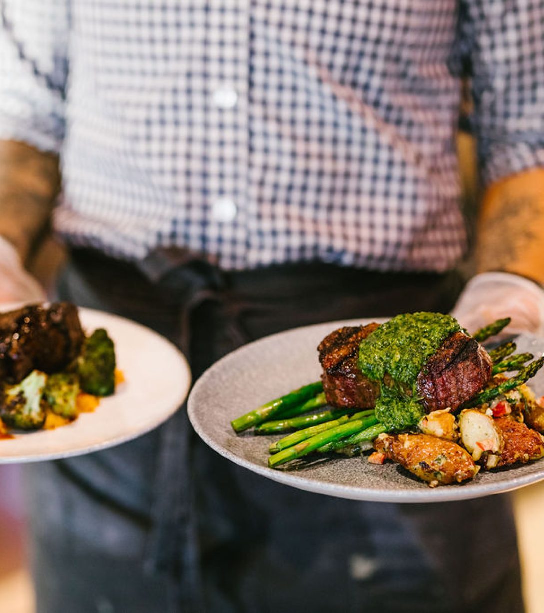 person holding plates of food