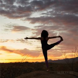 person doing yoga pose outside during sunset