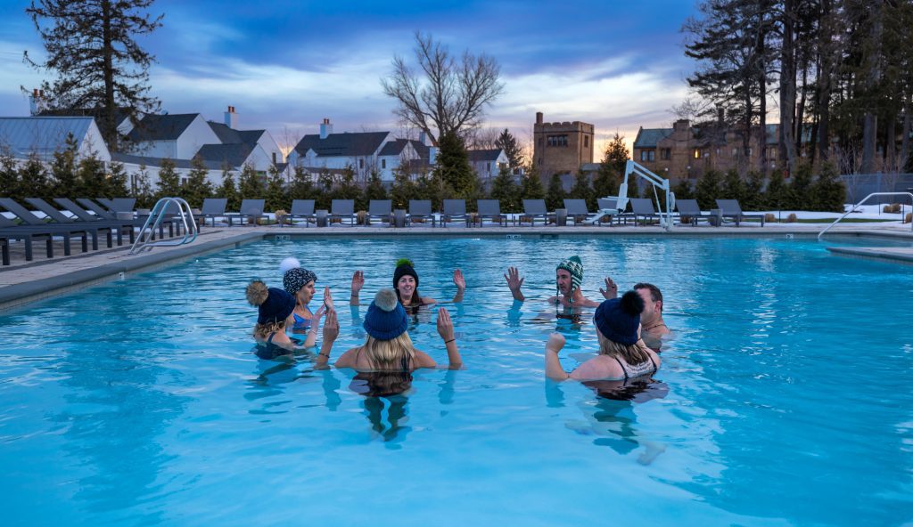 Miraval staff in winter pool, people wearing hats