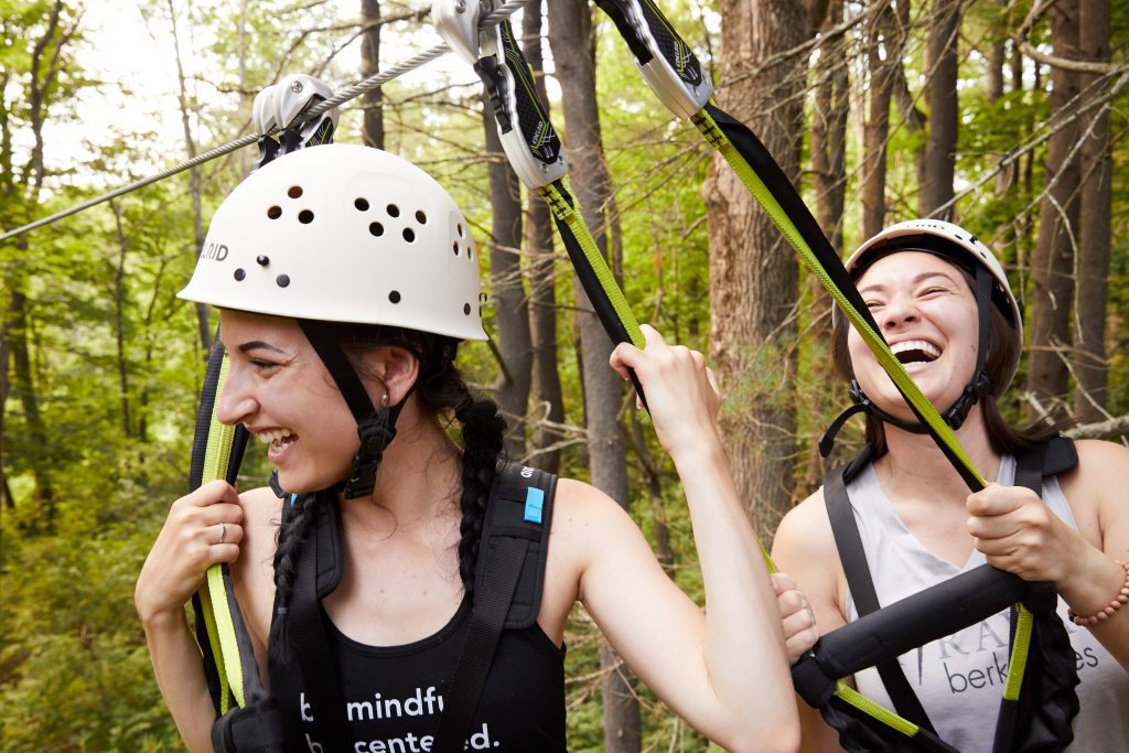 Women with helmets on zip line