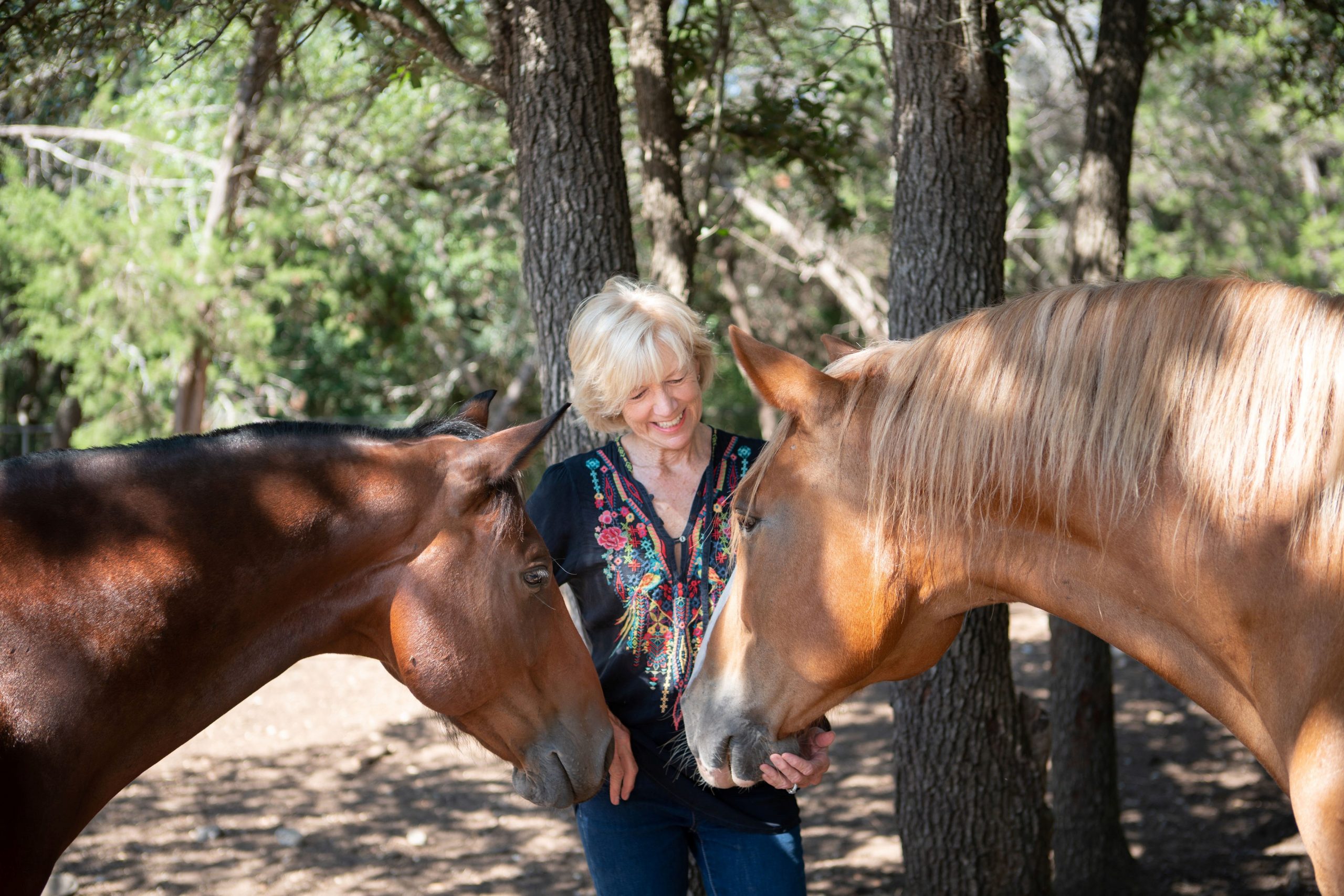 Paula Basden petting horses