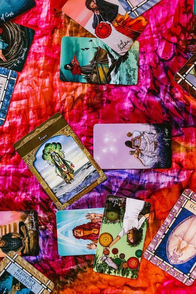 tarot cards laid out on a bright colored cloth