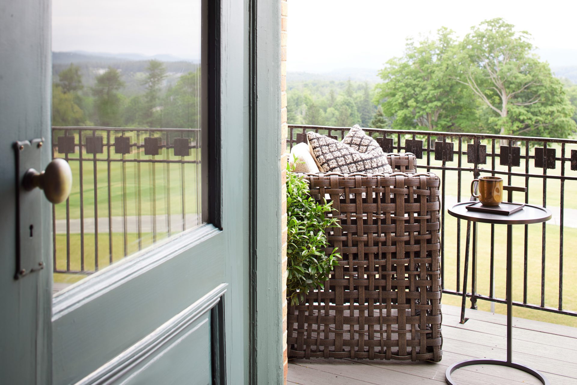 Wyndhurst guest room patio with chair and table overlooking landscape