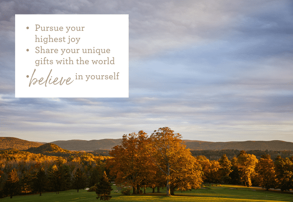 Golden trees in fall, cloudy blue sky and believe in yourself quote